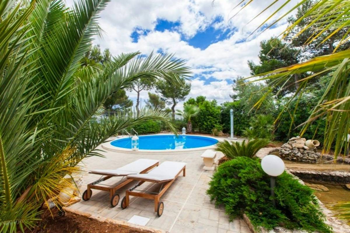 poolside accessory design pool umbrella that with weighted base, cantilever arm, and fade-resistant canopy over concrete pool deck